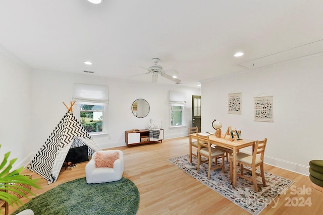 dining space featuring ceiling fan, a healthy amount of sunlight, and wood-type flooring