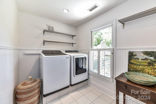 washroom with light tile patterned flooring and washing machine and clothes dryer