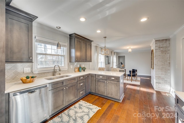 kitchen featuring stainless steel dishwasher, pendant lighting, dark hardwood / wood-style flooring, and sink