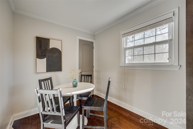 dining space with dark hardwood / wood-style floors and ornamental molding