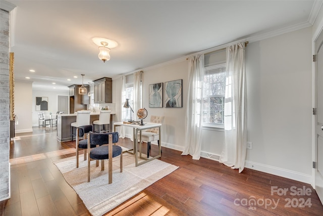 dining room featuring dark wood-type flooring and ornamental molding