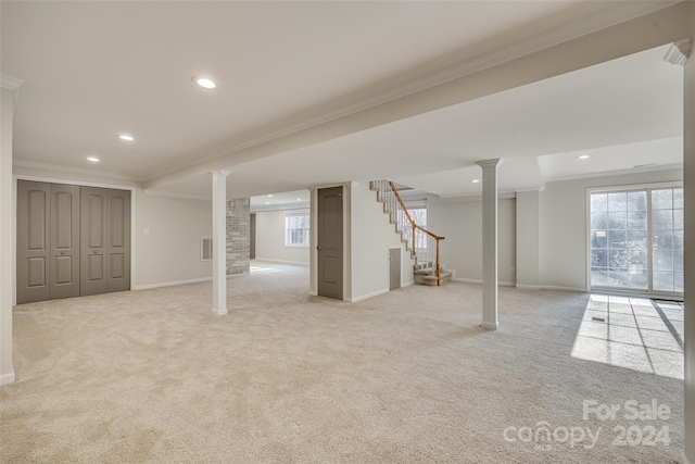 basement with light colored carpet and ornamental molding