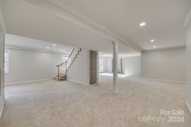 basement featuring crown molding and light colored carpet