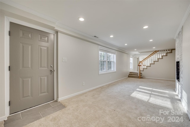 unfurnished living room with light colored carpet and crown molding