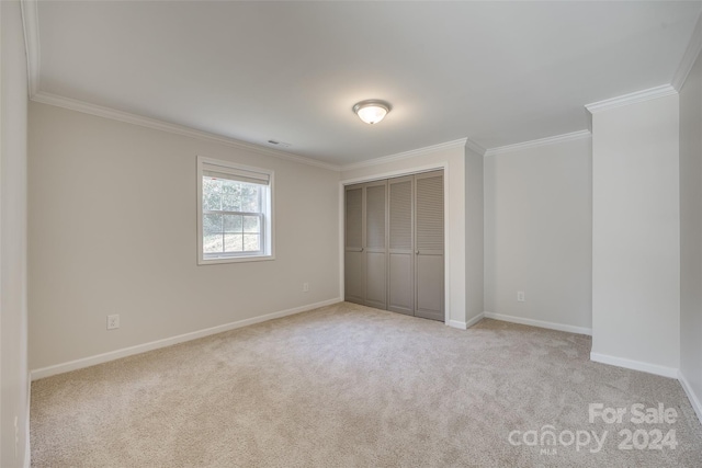 unfurnished bedroom featuring light carpet, a closet, and ornamental molding