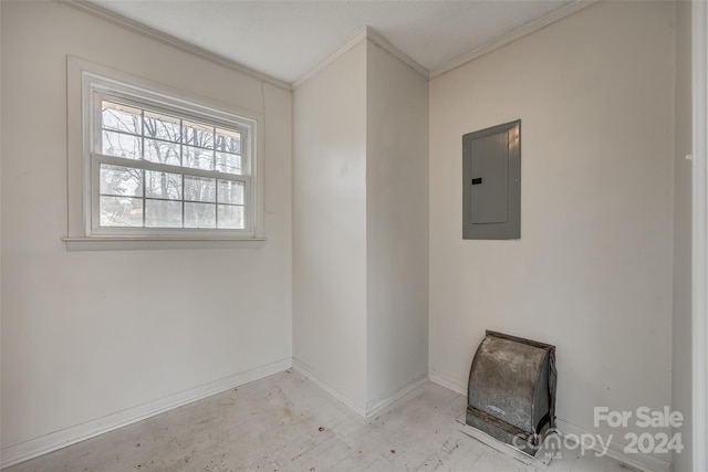 spare room with crown molding and electric panel