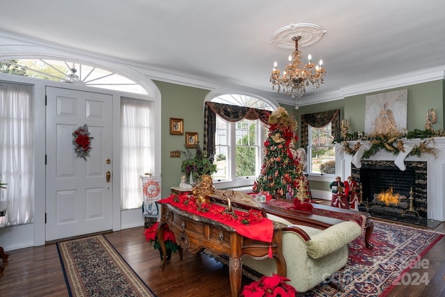 foyer entrance featuring crown molding, dark hardwood / wood-style floors, and an inviting chandelier