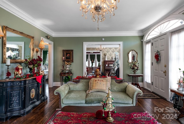 living room featuring crown molding, dark wood-type flooring, and an inviting chandelier