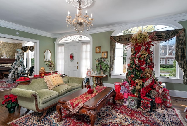 living room with hardwood / wood-style flooring, crown molding, and a notable chandelier