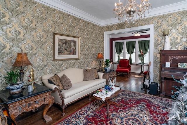 living room featuring hardwood / wood-style floors, ceiling fan with notable chandelier, and crown molding