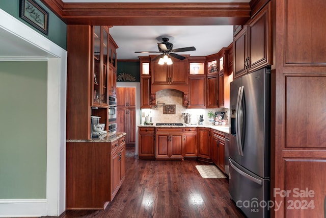 kitchen with appliances with stainless steel finishes, dark hardwood / wood-style flooring, tasteful backsplash, and crown molding