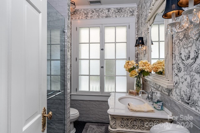 bathroom featuring vanity, toilet, tile walls, and crown molding