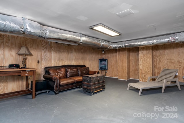 basement featuring wooden walls