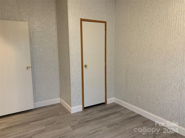 unfurnished bedroom with hardwood / wood-style flooring