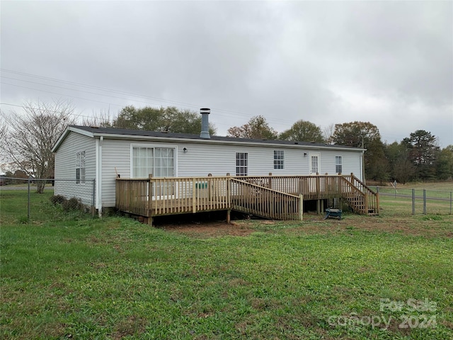 back of house with a lawn and a wooden deck