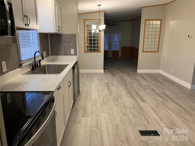 kitchen featuring sink, pendant lighting, white cabinets, black range with electric stovetop, and lofted ceiling