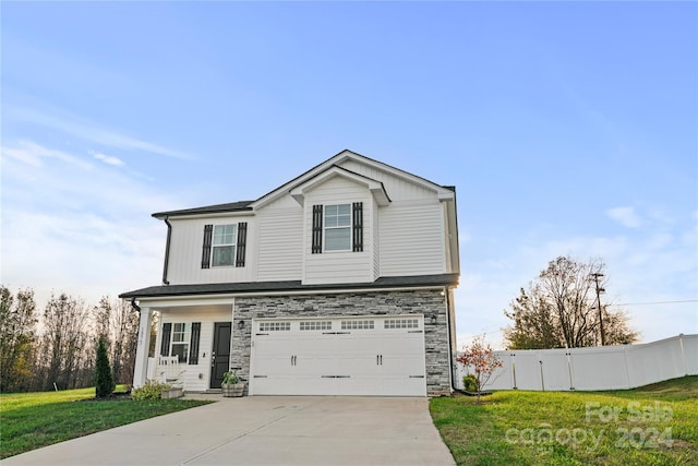 view of front property featuring a garage and a front lawn