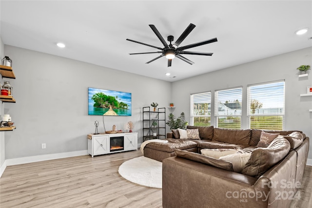 living room with light hardwood / wood-style floors and ceiling fan