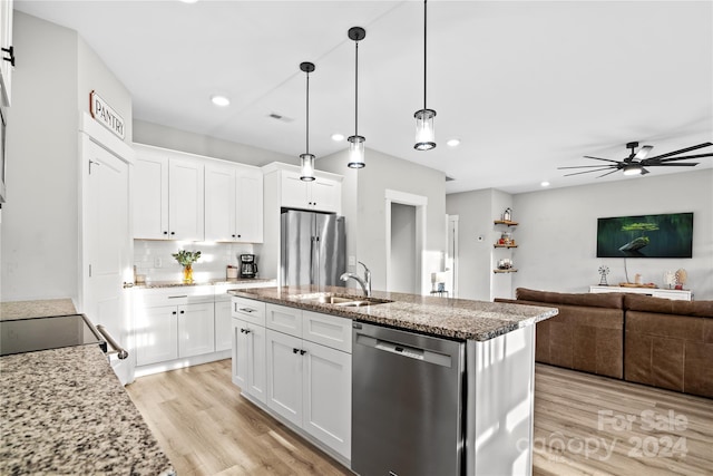 kitchen featuring ceiling fan, sink, appliances with stainless steel finishes, white cabinets, and light wood-type flooring