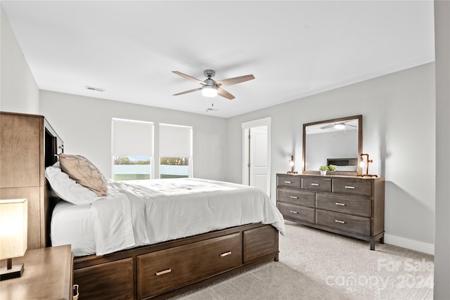 bedroom featuring light colored carpet and ceiling fan