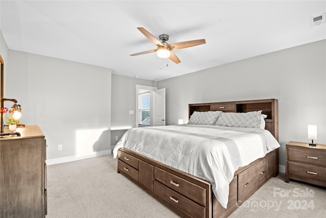 bedroom with ceiling fan and light colored carpet