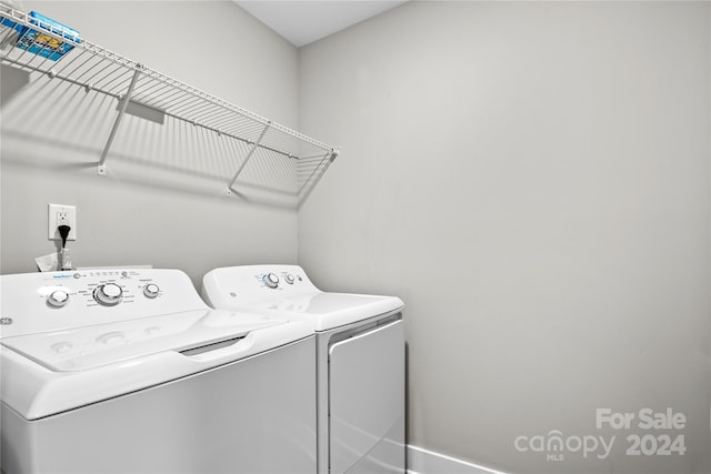 clothes washing area with separate washer and dryer