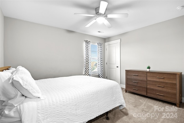 bedroom featuring ceiling fan and light carpet