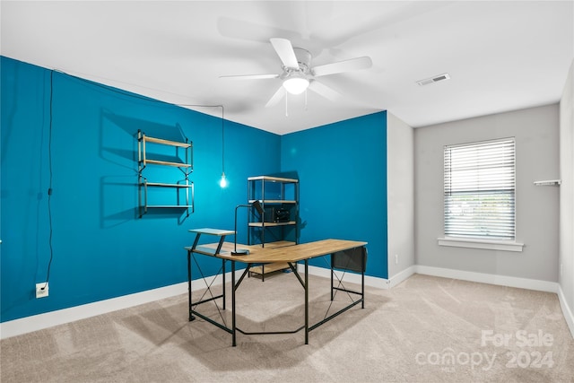 carpeted home office with ceiling fan