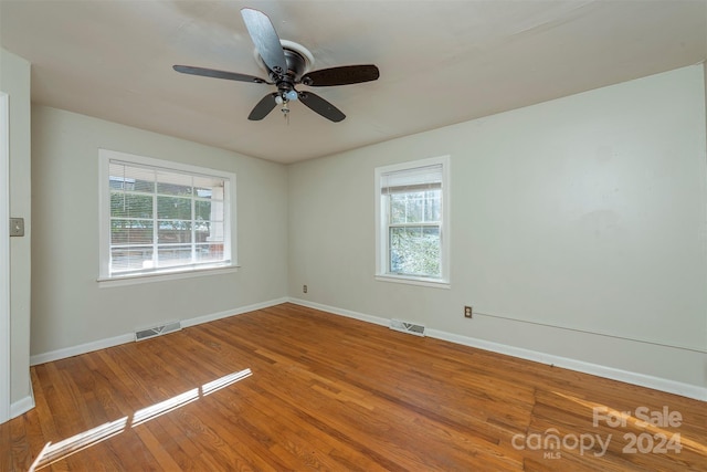 empty room with ceiling fan and wood-type flooring