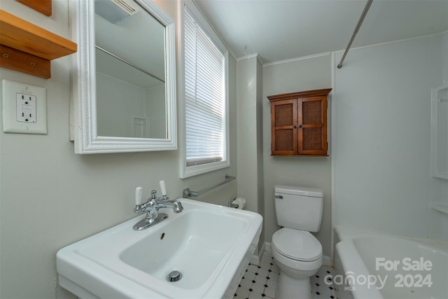 bathroom featuring a bathing tub, toilet, sink, and tile patterned flooring