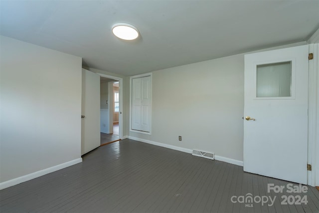 empty room with dark wood-type flooring