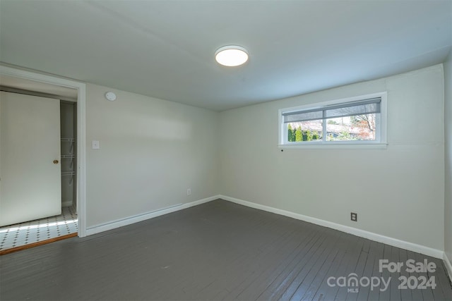 unfurnished room featuring dark hardwood / wood-style flooring