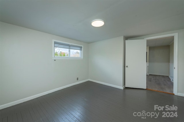 empty room featuring dark hardwood / wood-style flooring