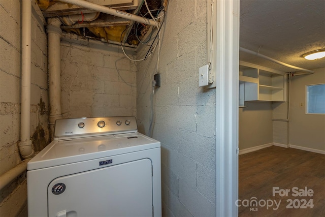 laundry room with washer / dryer and dark wood-type flooring