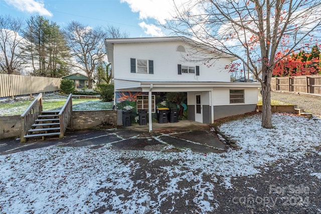 view of snow covered rear of property