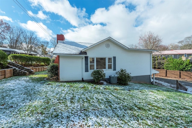 rear view of property featuring a yard and central air condition unit