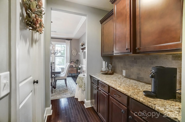 kitchen with tasteful backsplash, dark hardwood / wood-style floors, and light stone counters