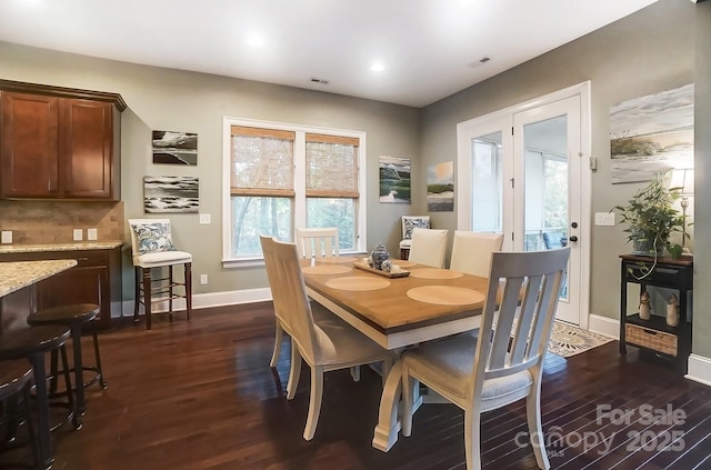 dining space with dark hardwood / wood-style floors