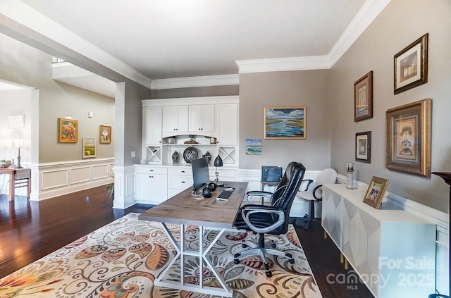 office with ornamental molding, built in desk, and dark hardwood / wood-style flooring