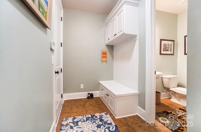 mudroom featuring dark tile patterned flooring