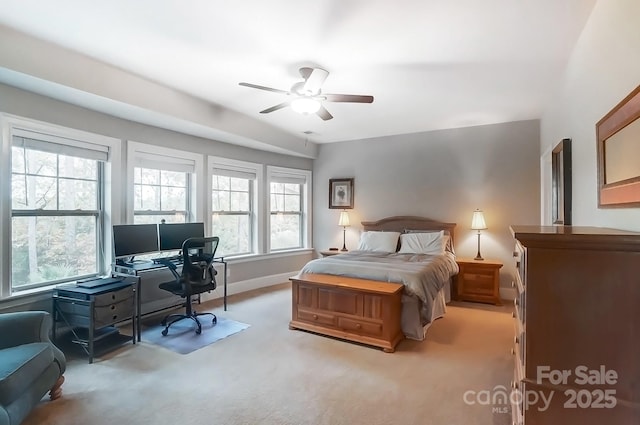 carpeted bedroom with multiple windows and ceiling fan