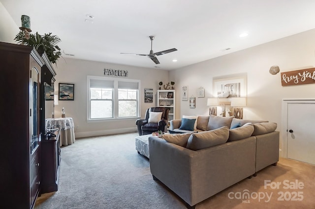 carpeted living room with ceiling fan