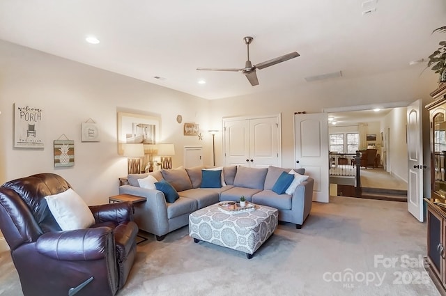 living room featuring light carpet and ceiling fan