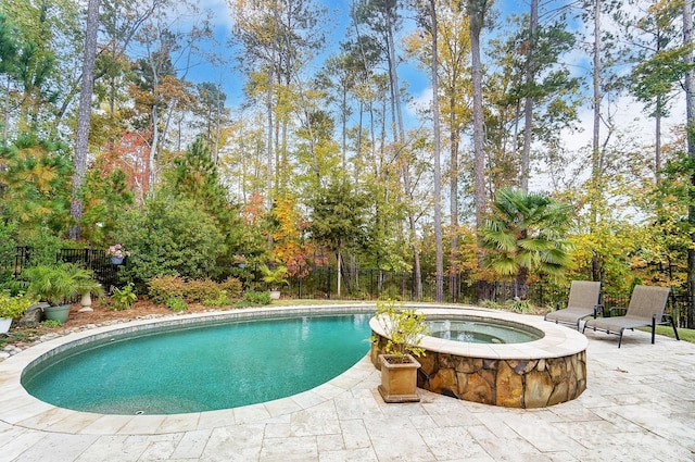 view of swimming pool featuring a patio area and an in ground hot tub