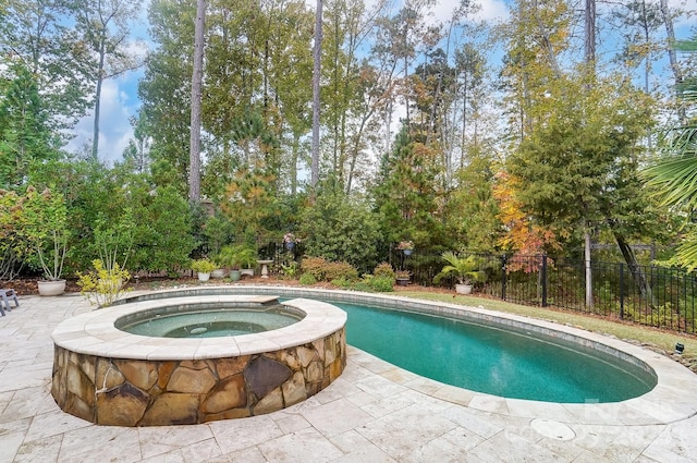 view of swimming pool with a patio area and an in ground hot tub