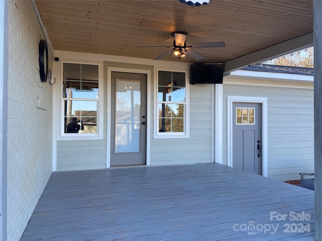 doorway to property featuring ceiling fan