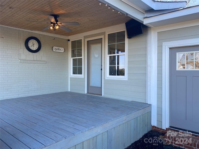 wooden terrace featuring ceiling fan