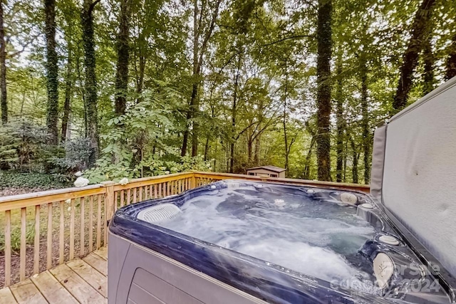 wooden deck with a hot tub