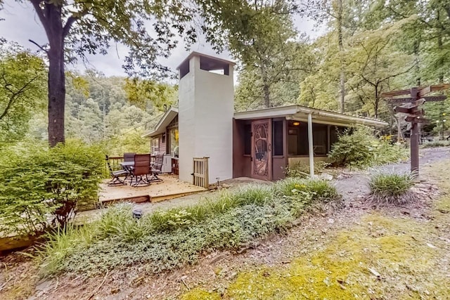 rear view of property featuring a deck