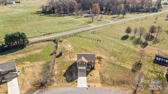 birds eye view of property featuring a rural view